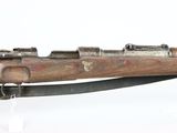 a close up of a rifle on a white surface with a white background