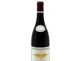 a bottle of red wine sitting on top of a white table