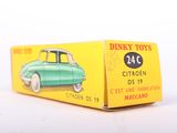 a green toy car sitting on top of a yellow box
