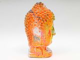 a statue of a buddha made out of orange beads
