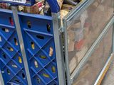 a blue cart with many items in it on the street