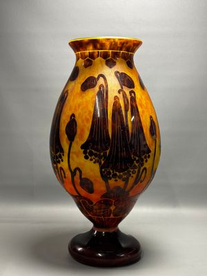 a vase that is sitting on a stand on a table