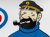 a sign with a picture of a man smoking a pipe