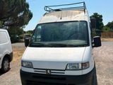a white van parked in a parking lot next to a white van