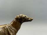 a statue of a dog that is standing on a pedestal