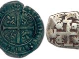 an old silver coin with a cross on it next to an old silver coin with a cross on it