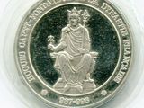 une image représentant une pièce d'argent sur laquelle figure une femme assise sur un trône