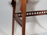 a small wooden desk with a mirror on top of it