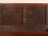 an old wooden chest with a glass door on top of it