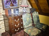 three chairs in a room with a painting on the wall