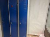 two blue lockers next to each other in a bathroom
