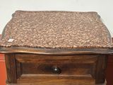 a wooden table with a marble top on it