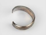 a close up of a metal ring on a white surface