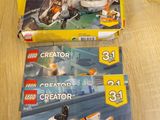 two lego creator sets are sitting on a table next to each other