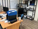 un bureau recouvert de nombreux papiers, dans une pièce
