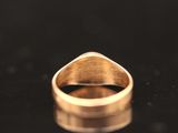 a close up of a gold ring on a black surface
