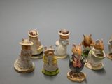 many small figurines of mice on a table
