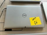 several laptops are sitting on a table with sticky notes attached to them