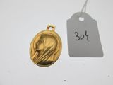 a close up of a gold medal with a tag on it