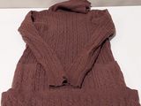 brown sweater on a white table with a white background