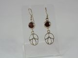 sterling silver earrings with garnetite stones on a clear acrylic stand