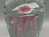 a glass vase with a pink jelly inside of it