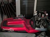a red machine that is sitting on the floor