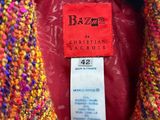 a close up of a colorful jacket with a tag on it