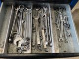 a lot of wrenches in a box on the floor