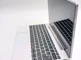 a laptop computer sitting on top of a white table