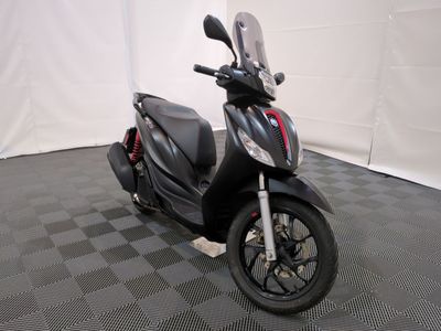 a motorcycle that is parked in a room with a checkered floor