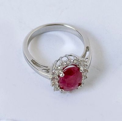 an image of a ruby and diamond ring on a white surface