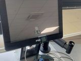 a computer monitor sitting on top of a desk