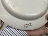 a person holding a white plate with writing on it
