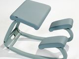 a blue chair that is sitting on a white surface