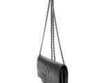 a black chanel bag with a chain hanging from it