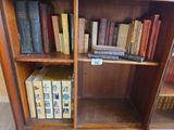 a book shelf with many books on it in a room