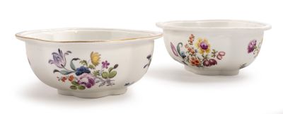 pair of porcelain bowls with floral designs on them on a white surface