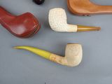 four different types of smoking pipes on the table