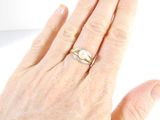 a woman ' s hand with a ring on it and a ring on her finger