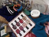 a picture of a pile of clothes and a book on a bed