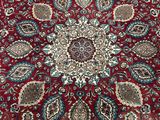 a close up of a red rug on a wooden floor