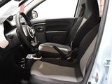 the interior of a small car with a steering wheel and a cup holder