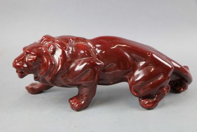 an image of a figurine of a lion on a white background