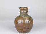 a brown vase sitting on a white surface