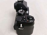a black camera sitting on a white surface
