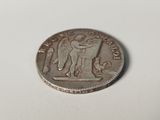 a coin with a statue on it sitting on a table