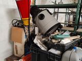 a trash can sitting on top of a bin in a garage