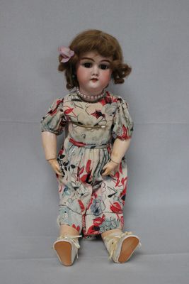 a small doll that is sitting on the ground