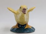 a yellow bird that is sitting on top of a blue object